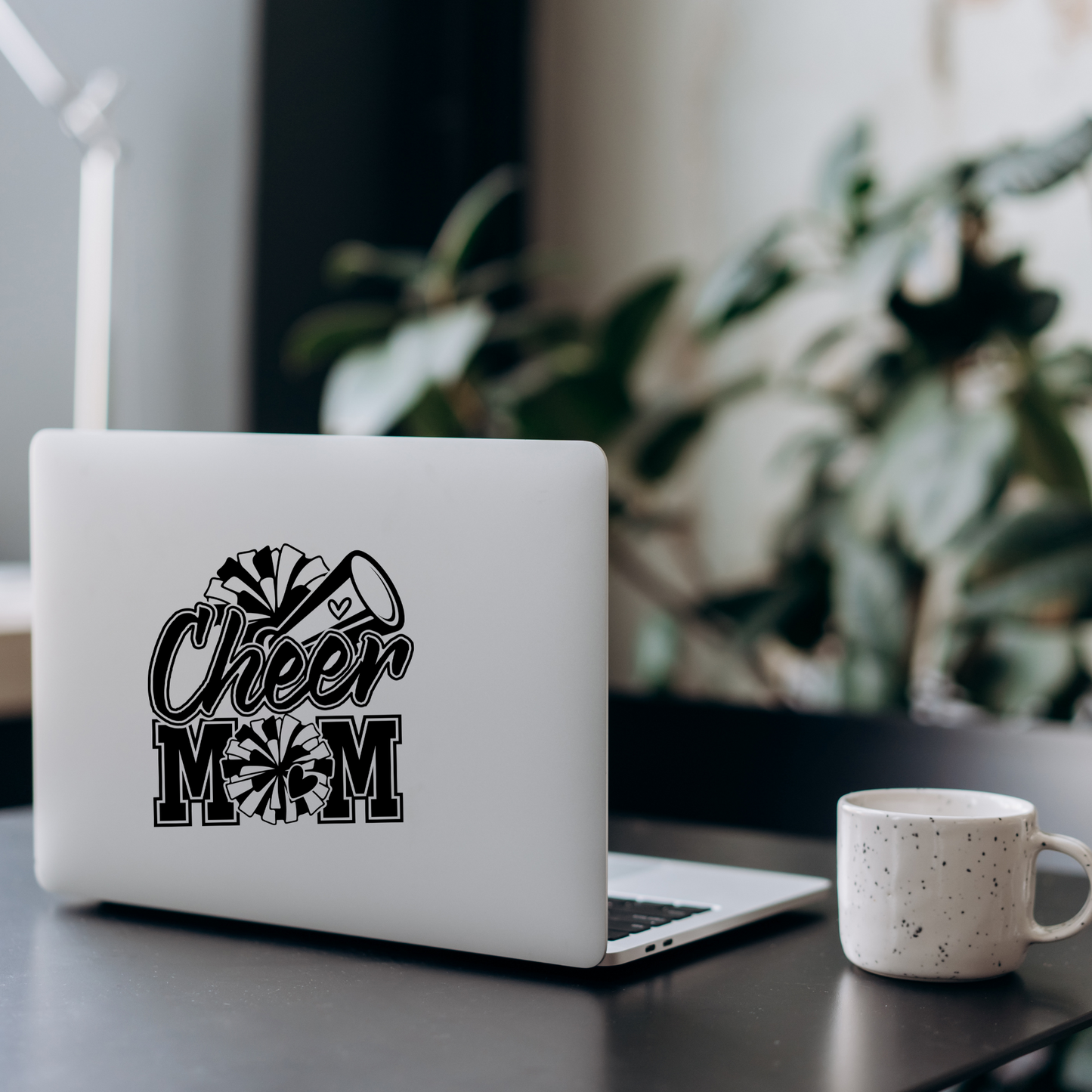 Black and white vinyl decal that says “Cheer Mom” with pom-poms, megaphone, and heart details