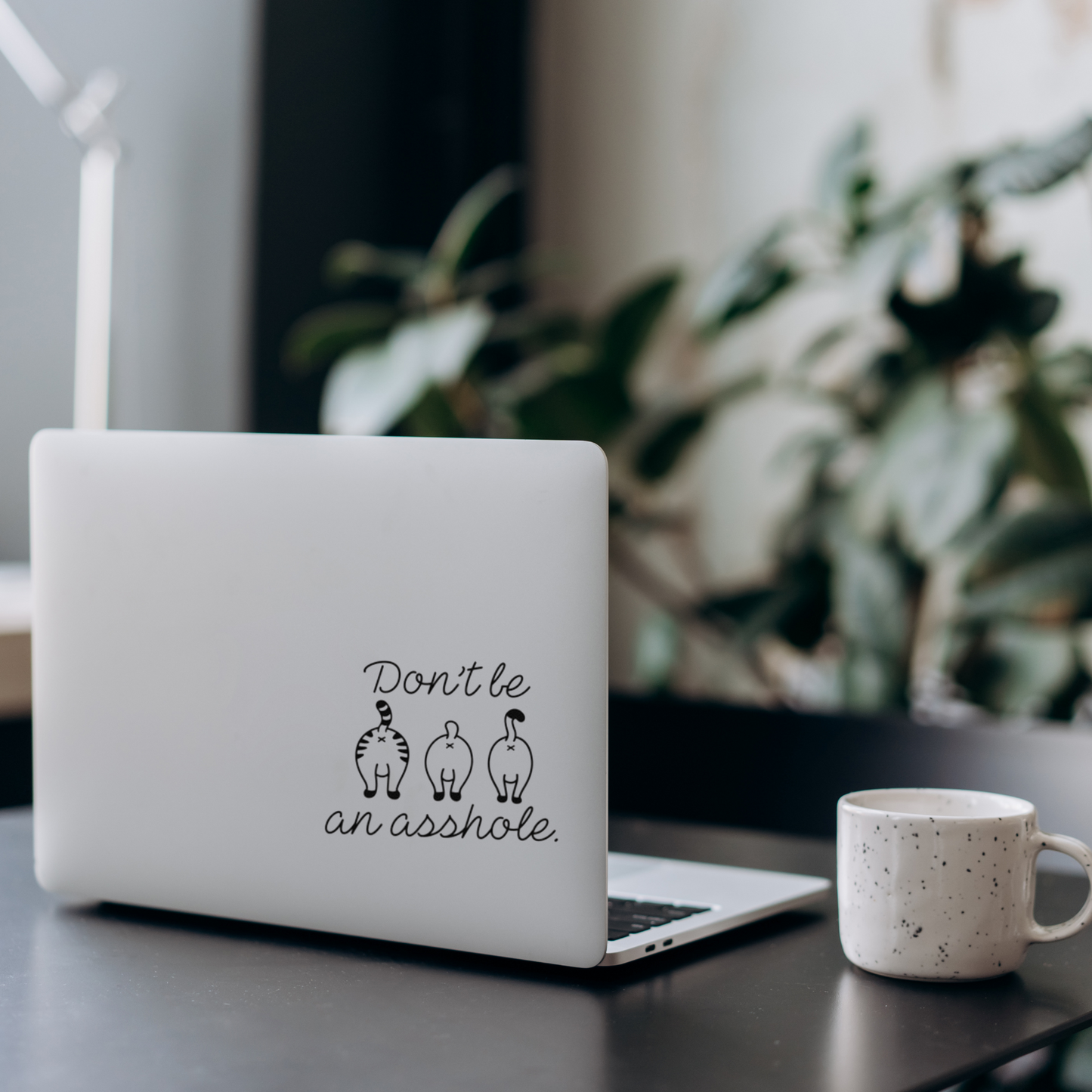 Vinyl decal with three cartoon cat butts and the phrase “Don’t be an asshole” in playful script