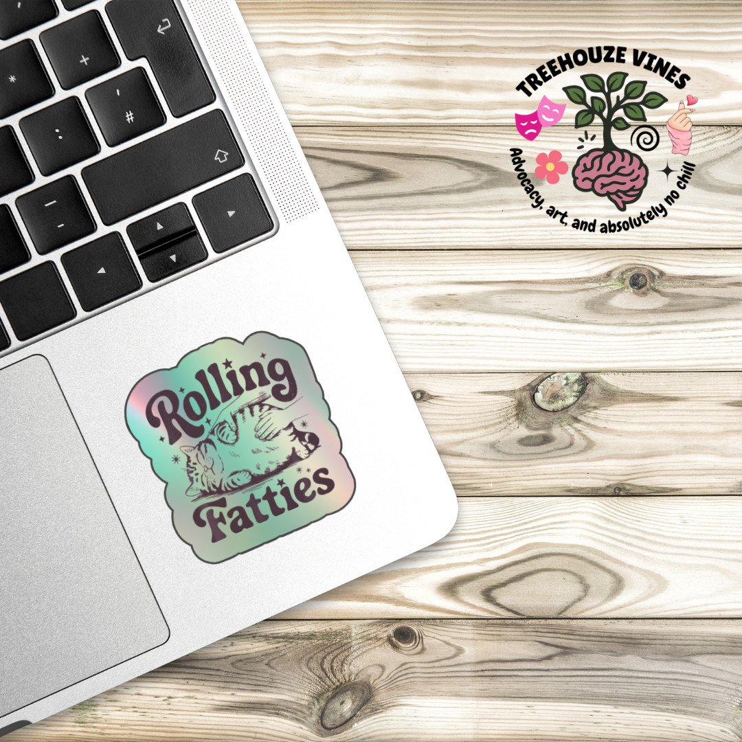 Holographic sticker with a hand rubbing a fat, relaxed cat and the phrase “Rolling Fatties” in playful black text