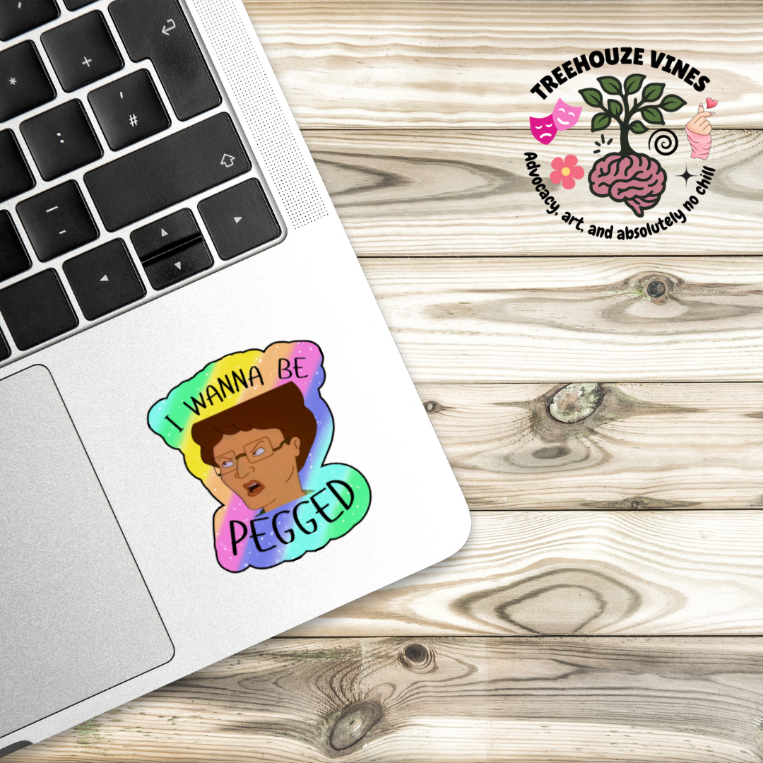 Holographic parody sticker with a cartoon woman and the phrase “I Wanna Be Pegged” in bold black lettering
