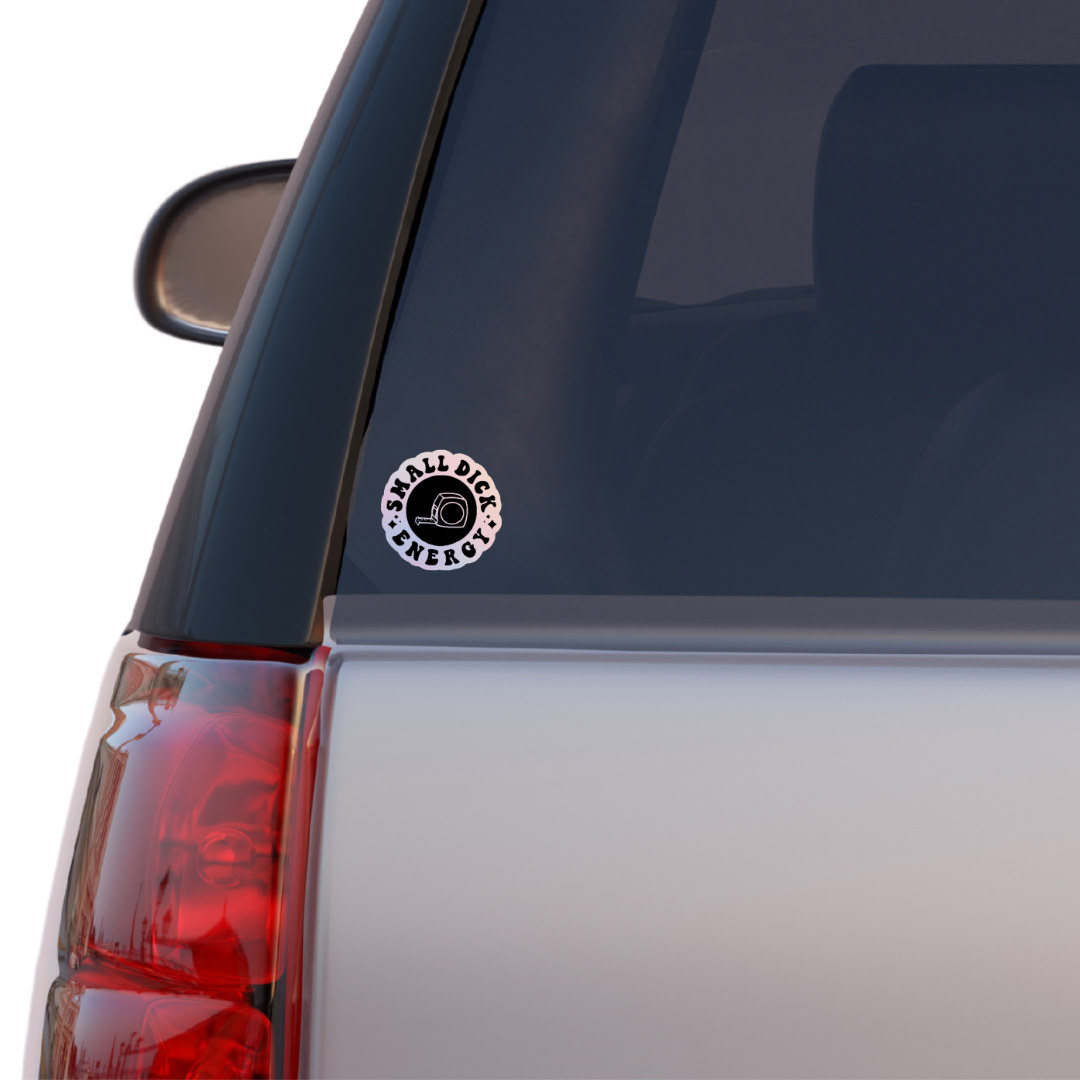 Round holographic sticker with the phrase “Small Dick Energy” and an illustrated tape measure in the center