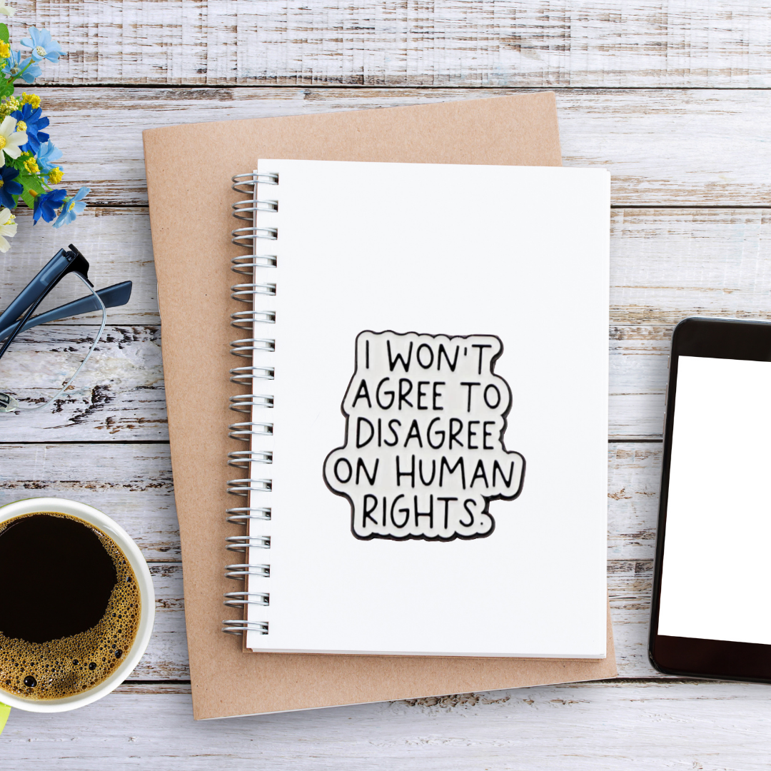 Sticker with handwritten-style text that says “I won’t agree to disagree on human rights” in bold black on white