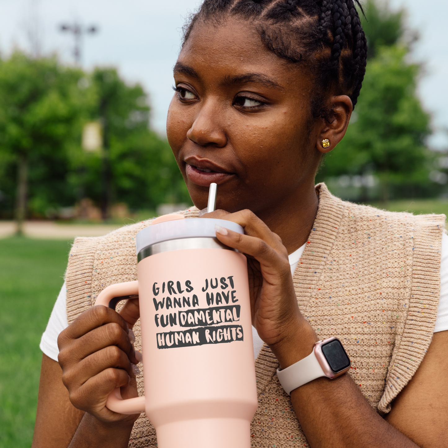 Woman holding a large water cup with a black vinyl decal that says girls just wanna have fundamental human rights