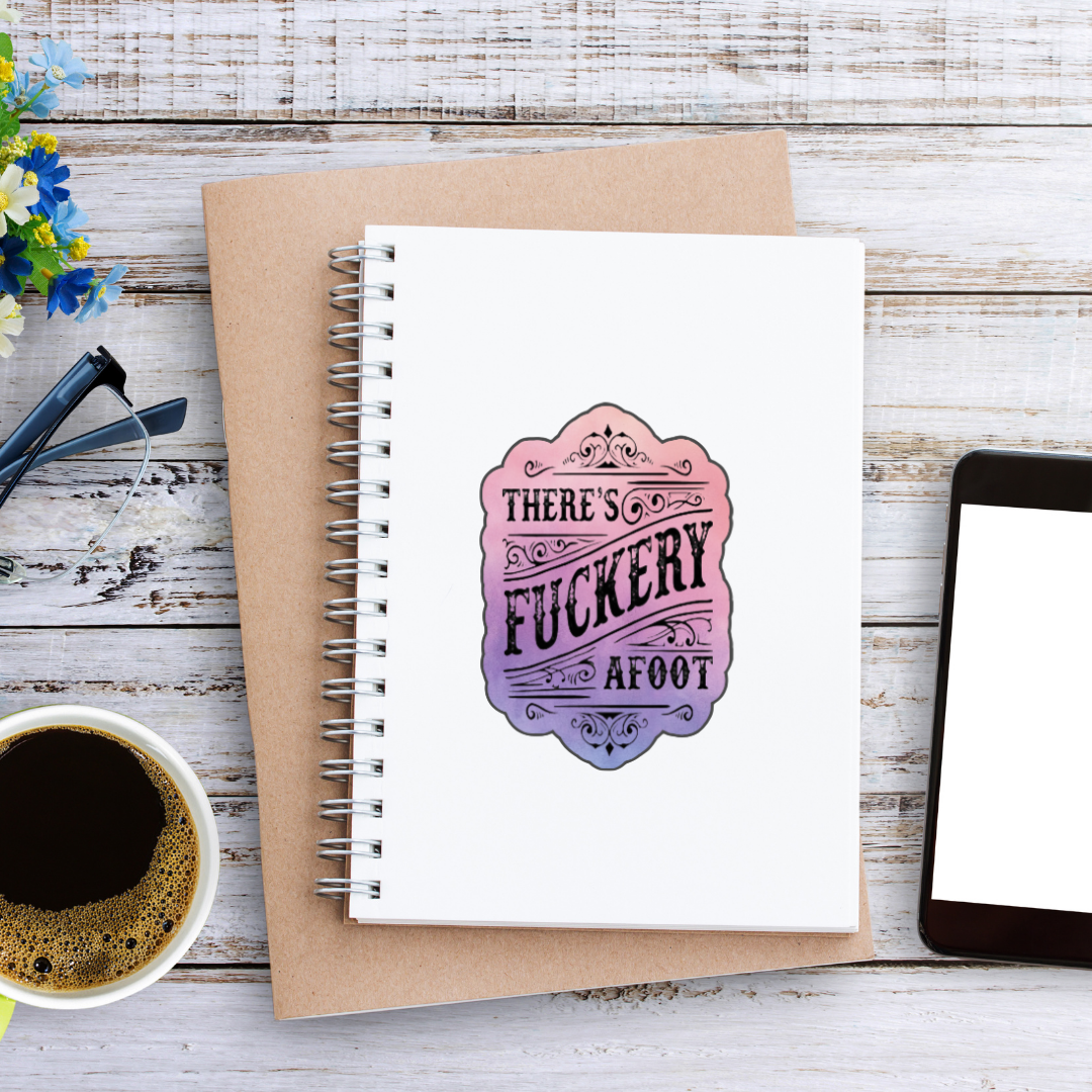 Sticker with ornate scrollwork and the phrase “There’s Fuckery Afoot” in black gothic-style lettering over a pink and purple gradient background