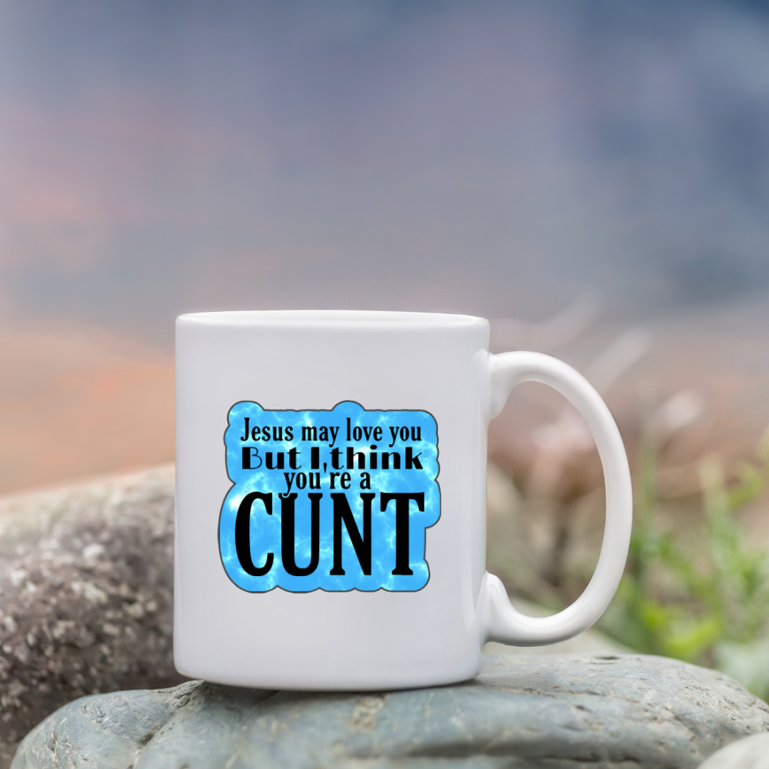 Holographic sticker that says “Jesus may love you but I think you’re a c*nt” in black text on a blue sparkle background