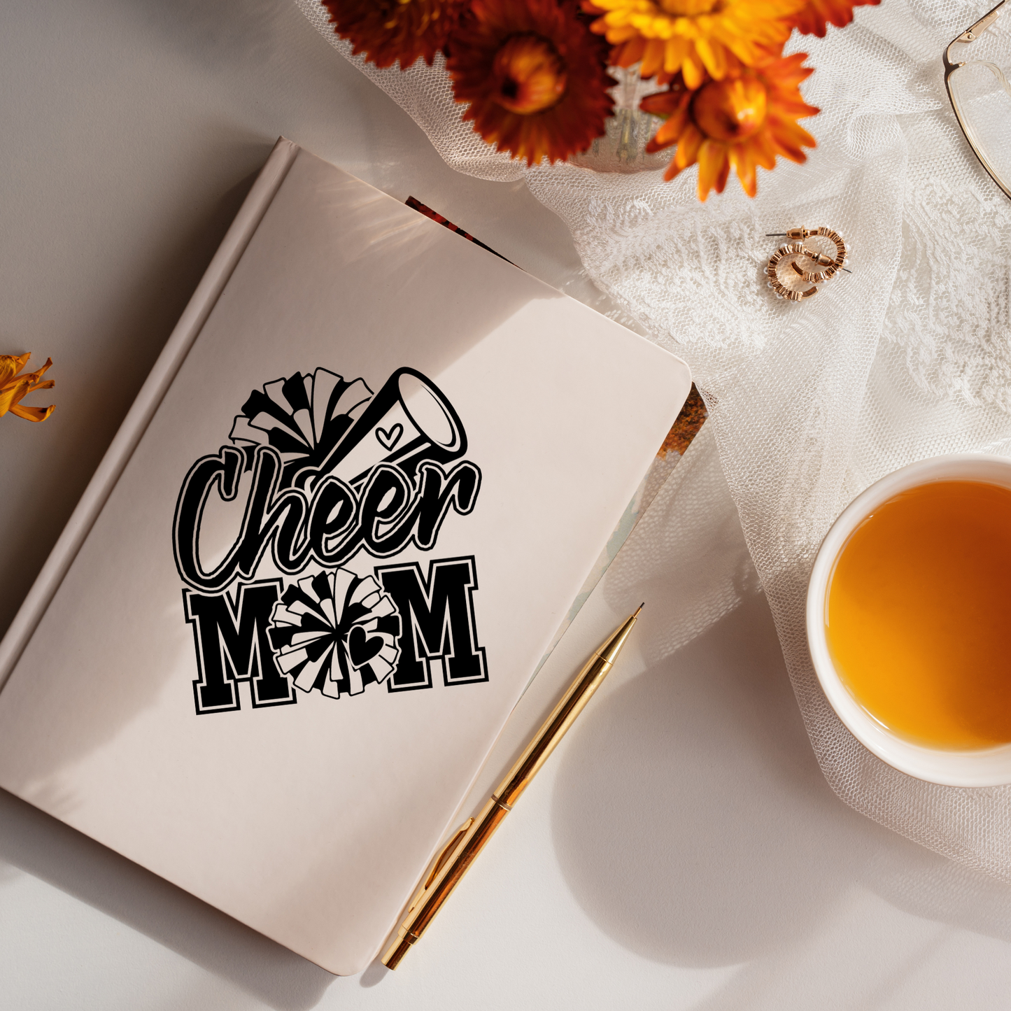 Black and white vinyl decal that says “Cheer Mom” with pom-poms, megaphone, and heart details