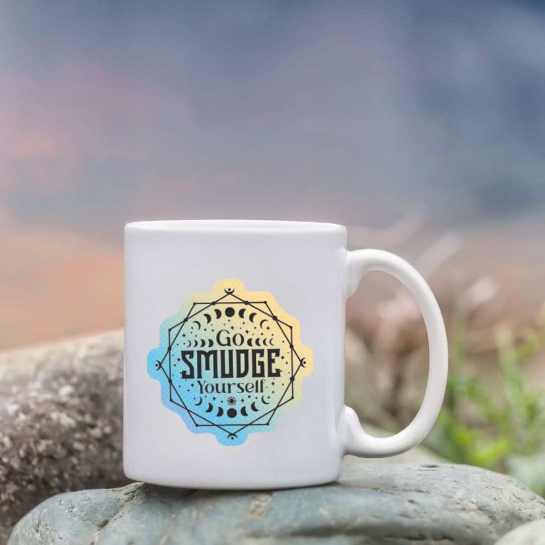 Holographic sticker with moon phases, sacred lines, and the phrase “Go Smudge Yourself” in bold black letters