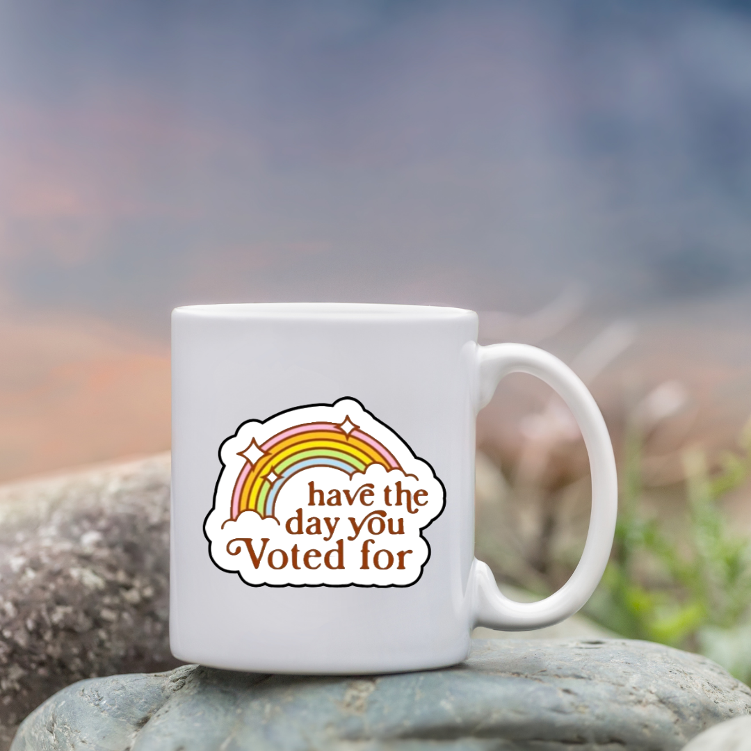 Retro rainbow sticker with the phrase “Have the Day You Voted For” in bold brown text and sparkles