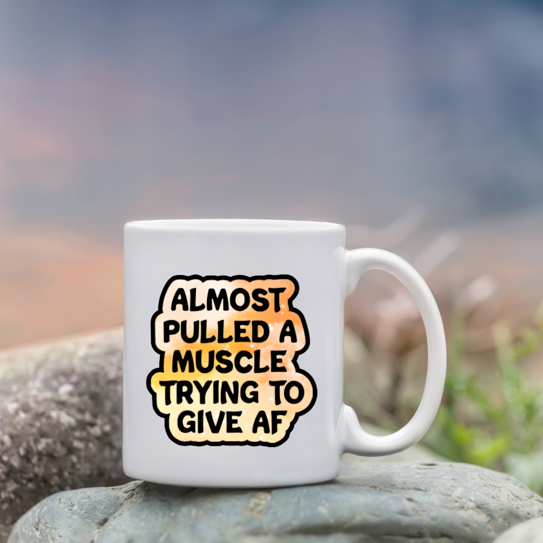 Holographic sticker that reads “Almost pulled a muscle trying to give AF” in bold black text over a peach-pink sparkle background