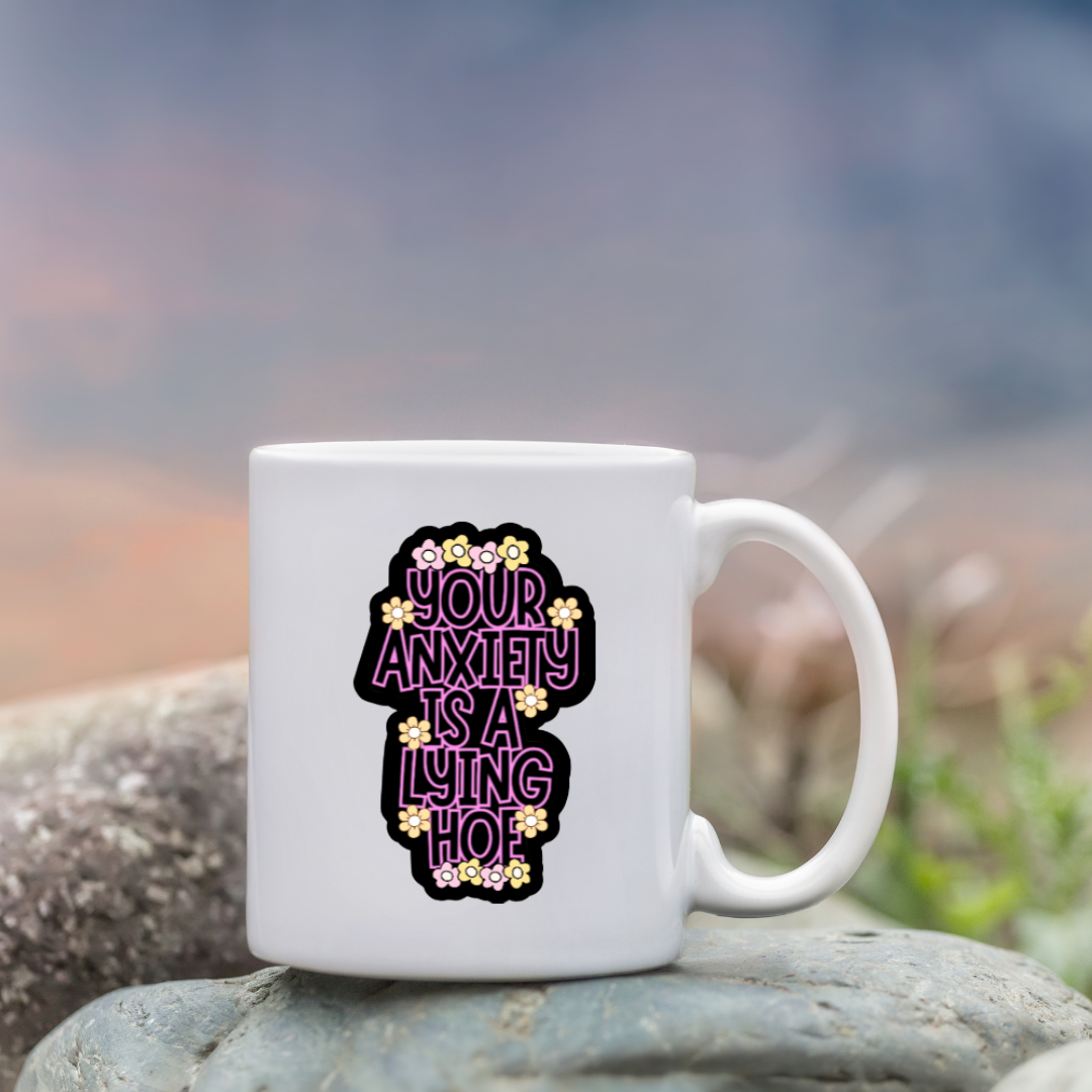 Holographic mental health sticker with the quote “Your Anxiety Is a Lying Hoe” in purple and white with flower doodles