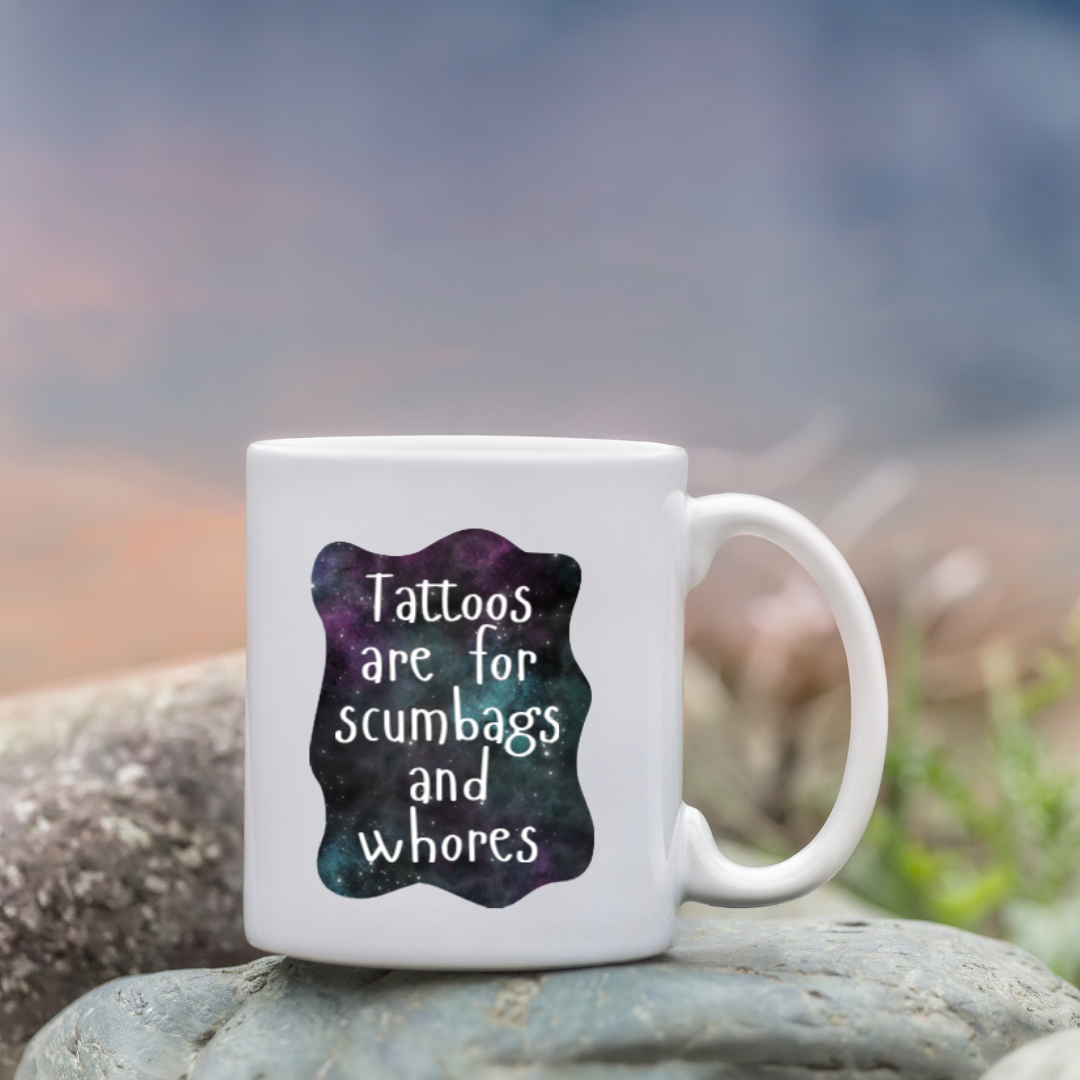 Sticker with a galaxy background and the phrase “Tattoos are for scumbags and whores” in white handwritten-style font