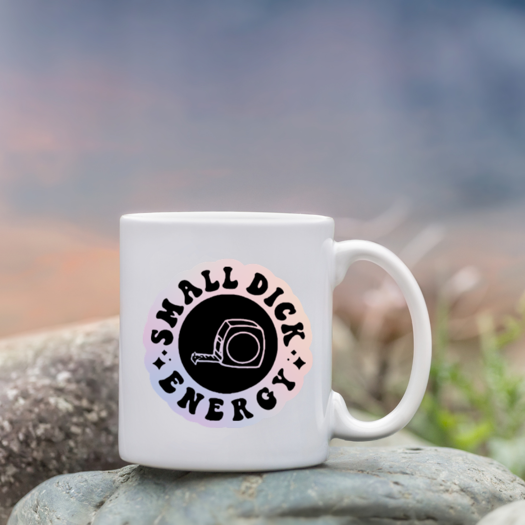 Round holographic sticker with the phrase “Small Dick Energy” and an illustrated tape measure in the center