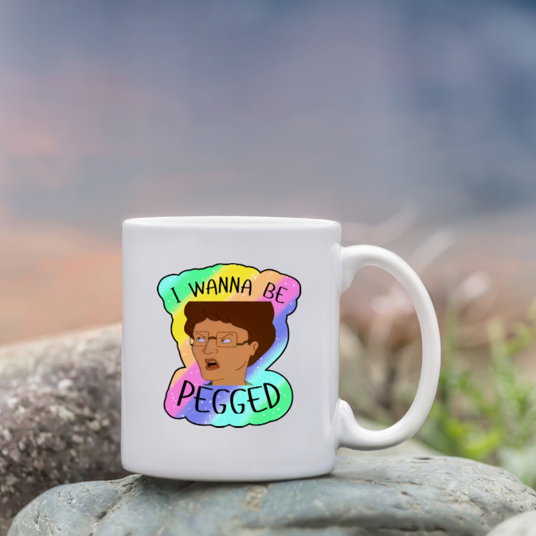 Holographic parody sticker with a cartoon woman and the phrase “I Wanna Be Pegged” in bold black lettering