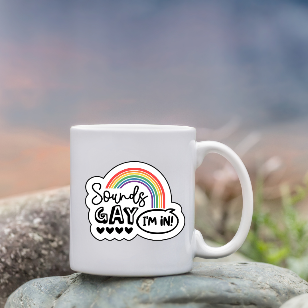 Vinyl sticker with rainbow arch and the phrase “Sounds Gay, I’m In!” in playful black font with five hearts beneath the word "Gay"