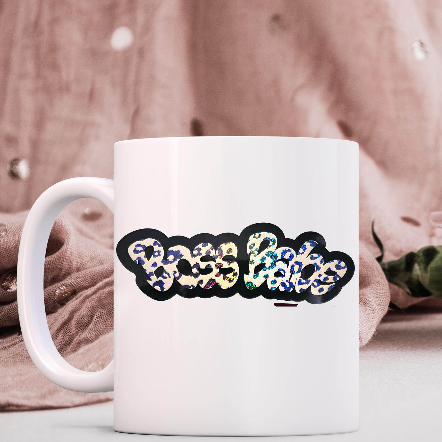 White mug with colorful 'Boss Lady' design on a soft fabric background
