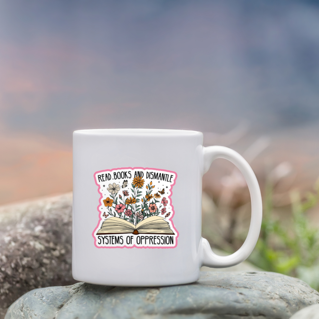 White mug with skull and floral design on a rock with a blurred natural background