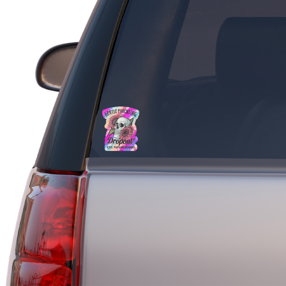 Sticker on a car window with a colorful design featuring a skull and text.