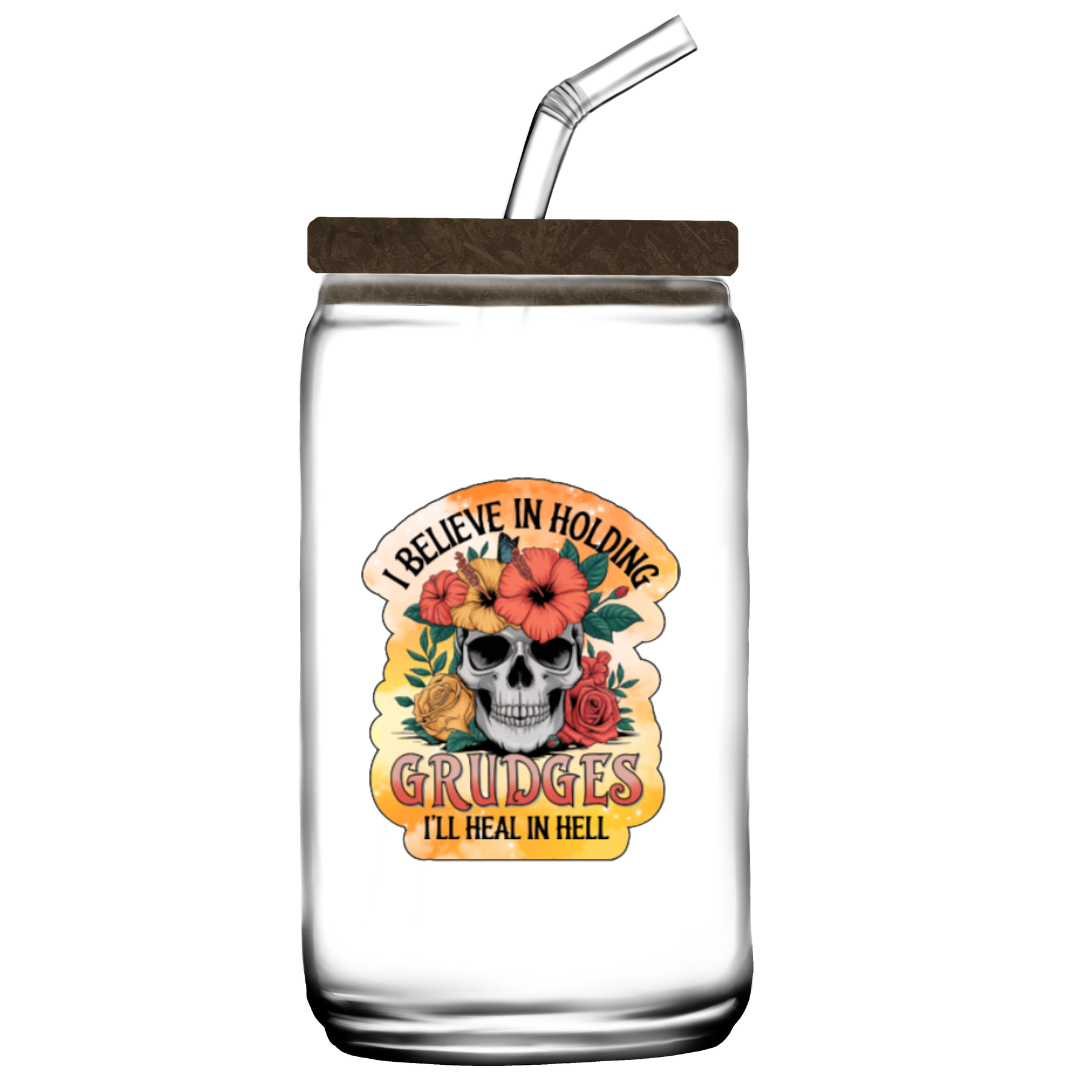 Clear glass mason jar with wooden lid and straw, featuring a skull and floral design with text.