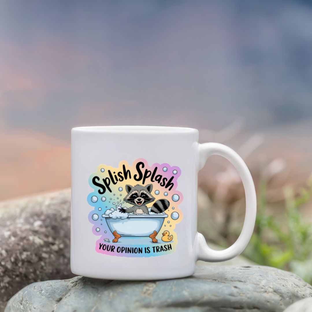 White mug with a raccoon illustration and text on a rock with a blurred natural background