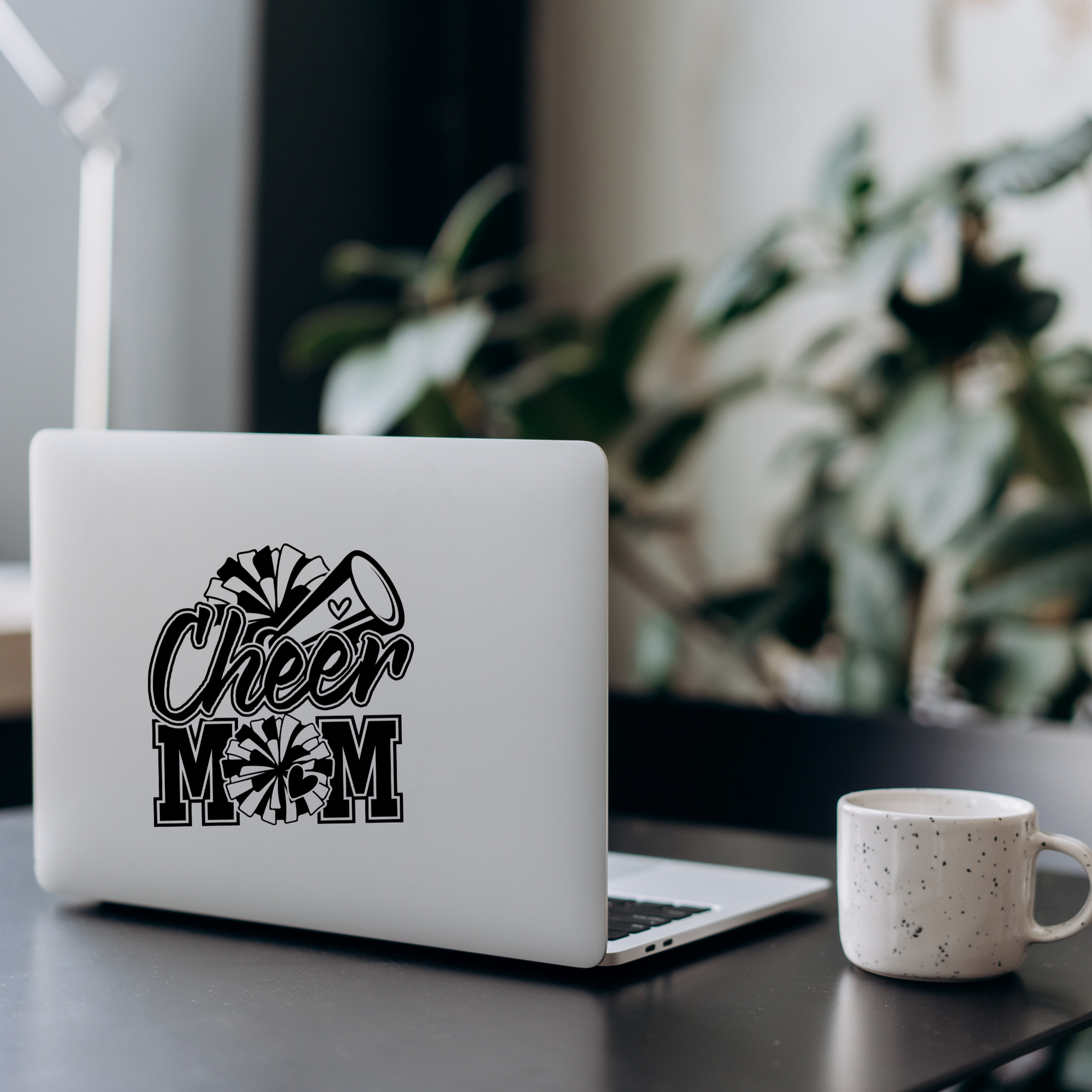 Black and white vinyl decal that says “Cheer Mom” with pom-poms, megaphone, and heart details