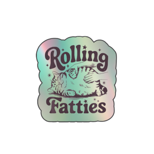 Holographic sticker with a hand rubbing a fat, relaxed cat and the phrase “Rolling Fatties” in playful black text