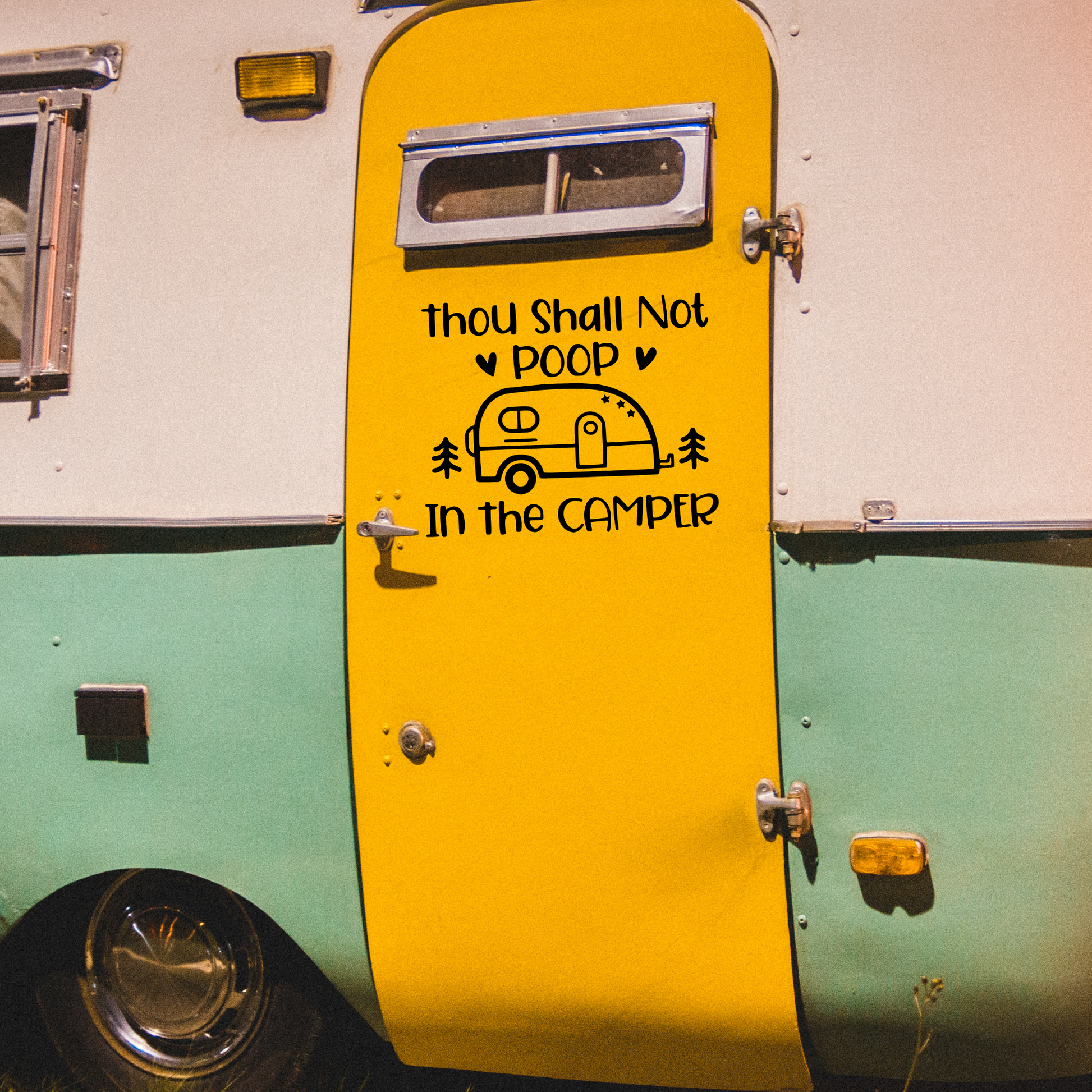 Green and tan vintage camper with a yellow door with a decal that says thou shall not poop in the camper