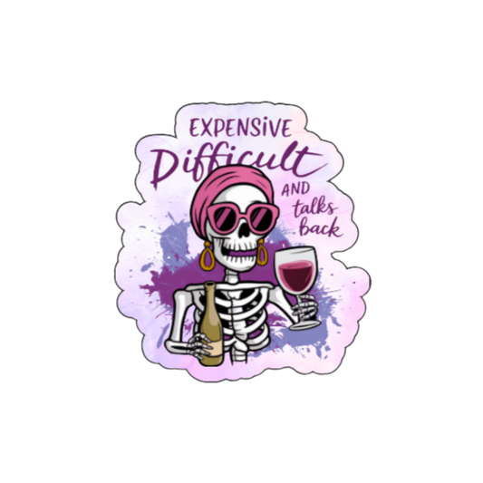 Holographic sticker showing a skeleton in a headwrap and earrings holding a wine glass, with the phrase “Expensive, Difficult, and Talks Back.”