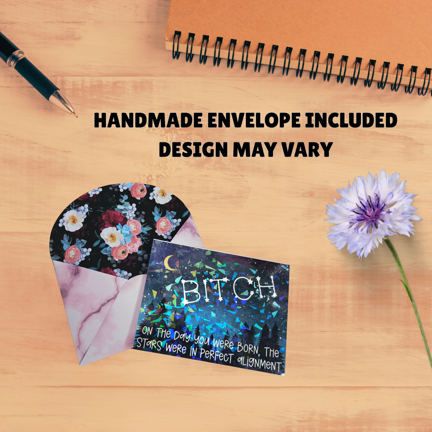 Greeting card with holographic starry design reading “BITCH – On the day you were born, the stars were in perfect alignment,” paired with a floral-lined envelope.