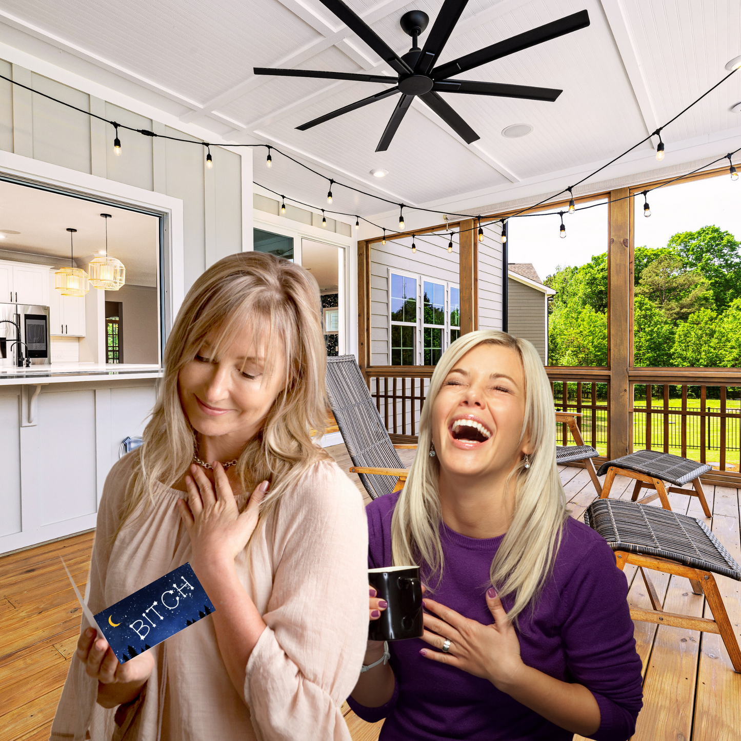 Two women on a porch with one holding a card that says 'Bitch' in a casual setting.