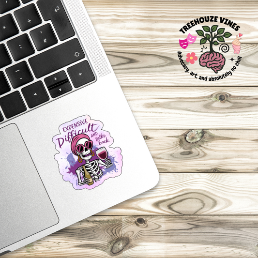Laptop with a sticker on a wooden surface, featuring the Treehouze Vines logo.