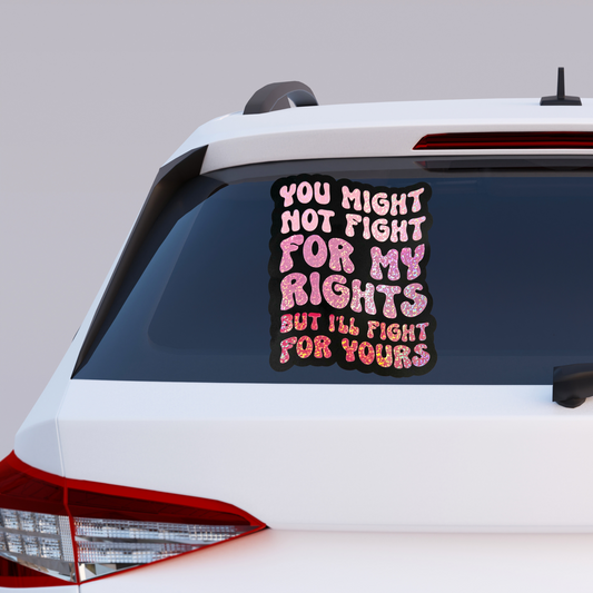 Car with a decal on the back window featuring text.
