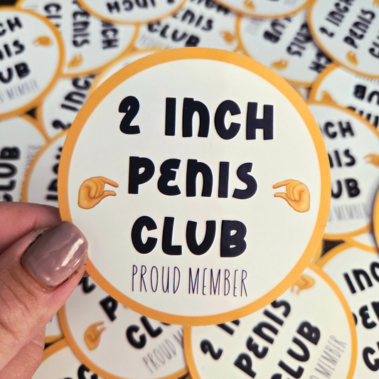 Circular sticker with '2 Inch Penis Club Proud Member' text held by a hand.